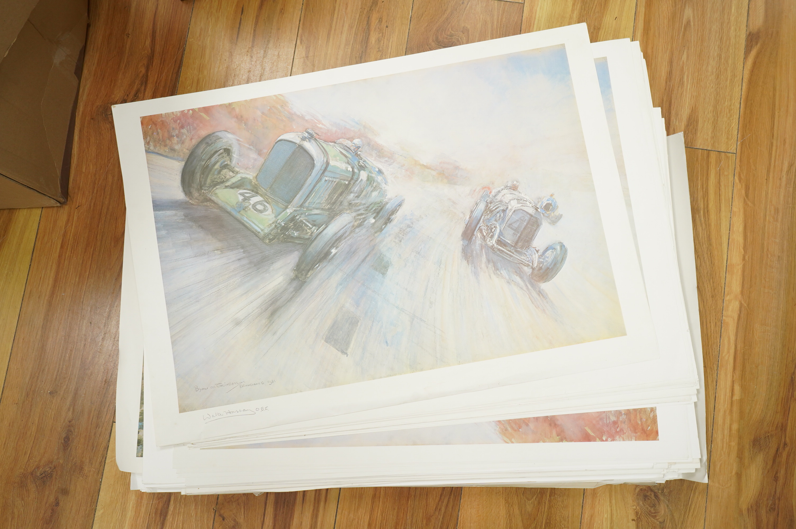 Two framed and signed motor racing lithographs by Anthony Heal and Walter Hassan of Le Mans and Brookslands racing scenes, the largest frame 61.5 x 76cm, together with a folio containing a large number of unframed simila
